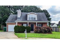 Charming one-story brick home with a well-maintained lawn and covered entrance at 4707 Golod Way, Lithonia, GA 30038