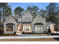 Stunning two-story home boasts elegant brickwork, black window trim, and a beautifully landscaped front yard at 125 Maison Court, Roswell, GA 30076