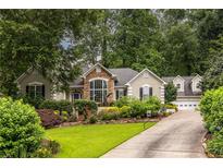 Charming home featuring a beautifully landscaped front yard with stone accents and a well-maintained lawn at 3300 Pierce St, College Park, GA 30337
