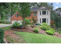 Charming home with a well-maintained front yard and garden landscaping at 2206 Heritage Trace Dr, Marietta, GA 30062