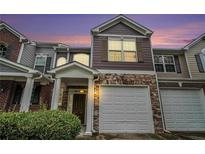 Charming townhome featuring stone accents, a covered entrance, and an attached one car garage at 2731 Pierce Brennen Ct, Lawrenceville, GA 30043