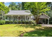 Charming home featuring a inviting front porch, manicured lawn, and convenient carport at 3754 Wyntuck Nw Cir, Kennesaw, GA 30152