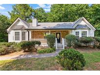 Charming ranch-style home featuring a stone facade, well-maintained landscaping, and a welcoming front porch at 165 Lost Lake Trl, Villa Rica, GA 30180