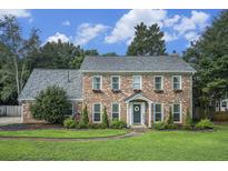 Charming two-story brick home with a well-manicured lawn, flower boxes and a welcoming front entrance at 4271 Keheley Ne Rd, Marietta, GA 30066