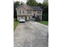 Two-story home with neutral siding, double windows, and extended driveway at 120 Alfred Dr, Carrollton, GA 30116