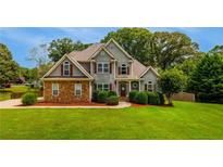 Charming two-story home with a well-manicured lawn and mature trees at 168 Gatlin Ridge Run, Dallas, GA 30157