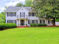 Charming two-story home with a well-manicured lawn and a lovely front porch at 1808 Jacksons Creek Dr, Marietta, GA 30068