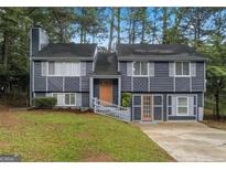 Charming two-story home with gray siding, mature trees, and a welcoming entrance at 2106 Singer Way, Lithonia, GA 30058