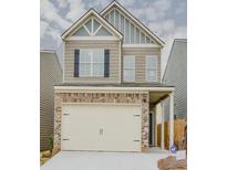 Charming two-story home features a brick and siding facade, and an attached two-car garage at 2010 Shortleaf Rd, Fairburn, GA 30213
