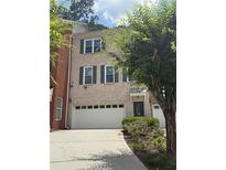 Charming brick townhome featuring an attached garage and manicured landscaping at 2895 Brandl Cove Ct # 4, Marietta, GA 30067