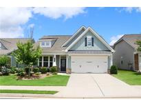 Charming home with blue siding, well-manicured lawn, and a two-car garage at 605 Oak Ln, Canton, GA 30114