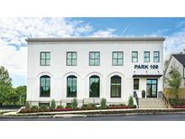 Modern two-story building with a white facade, black framed windows, and professionally landscaped entrance at 108 Park Pl # 110, Decatur, GA 30030