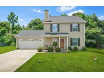 Charming two-story home with a well-manicured lawn and attached garage at 30 Creek Bottom Dr, Covington, GA 30014