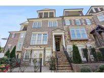 Elegant townhome with stone and brick facade, rooftop terrace, and inviting front entrance at 1117 Cordia Ave, Atlanta, GA 30318