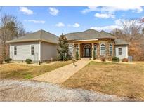 Lovely stone-accented home with brick walkway, manicured lawn, and charming architectural details at 1452 Redwine Rd, Fayetteville, GA 30215