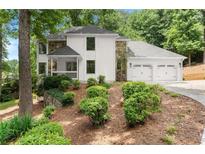 Beautiful two-story home with white siding, stone accents, three-car garage, and mature landscaping at 2855 Lamer Trce, Marietta, GA 30066