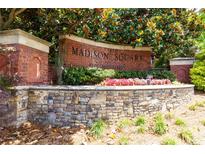 Attractive brick sign for Madison Square at Auburn Woods community entrance framed by colorful landscaping at 1850 Cotillion Drive # 2118, Dunwoody, GA 30338