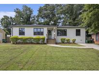 Charming one-story home featuring a white exterior, well-manicured lawn, and inviting curb appeal at 3135 Bluebird Ln, Decatur, GA 30032