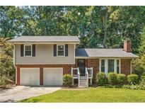 Charming two-story home with a brick and siding exterior, attached two-car garage, and landscaped front yard at 190 Windflower Trce, Roswell, GA 30075