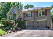 Charming two-story home featuring a two-car garage, stone accents, and well-manicured landscaping at 263 Bennett Farms Trl, Acworth, GA 30102