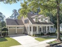 Charming home featuring a welcoming front porch, well-manicured landscaping, and an attached two-car garage at 504 Telfair Park, Peachtree City, GA 30269
