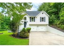 Charming two-story home features a well-manicured lawn, two-car garage and classic architectural details at 5870 Shadewater Dr. Dr, Cumming, GA 30041