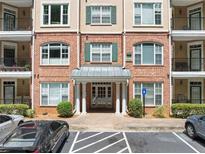 Brick building exterior featuring balconies, ample parking, and well-maintained landscaping at 2303 Stratford Commons Commons, Decatur, GA 30033