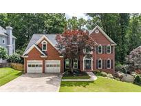 Beautiful two-story brick home featuring a two-car garage and well-manicured lawn at 4955 Day Lily Nw Way, Acworth, GA 30102
