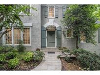 Charming front door with a stone walkway and lush landscaping at 80 Stratford Ne Pl, Atlanta, GA 30342
