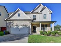 Charming two-story home featuring a brick facade, well-manicured lawn, and an attached two-car garage at 829 Still Hill Ln, Lawrenceville, GA 30045