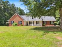Charming brick home with well-maintained lawn and inviting curb appeal, perfect for a Gathering at 1102 Ola Dale Ct, Mcdonough, GA 30252