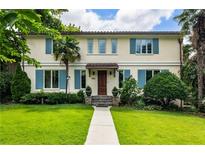 Charming two-story home with blue shutters, lush lawn, and mature trees giving great curb appeal at 2837 N Hills Ne Dr, Atlanta, GA 30305