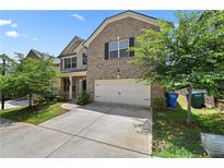 Charming two-story brick home featuring a two-car garage, well-kept lawn, and inviting curb appeal at 6468 Panasa Ct, Tucker, GA 30084