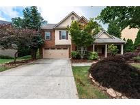 Charming two-story home featuring a brick facade, covered porch, and a well-maintained front yard at 1336 Nathan Mauldin Dr, Lawrenceville, GA 30043