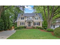 Charming two-story home featuring a manicured lawn, mature trees, and inviting curb appeal with a second story balcony at 2697 N Thompson Ne Rd, Atlanta, GA 30319