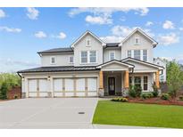 Beautiful three-car garage home with manicured lawn and craftsman style columns at 4830 Briscoe Dr, Cumming, GA 30028