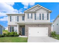 Charming two-story home with a brick and siding facade, manicured lawn, and attached two car garage at 7814 Messina Ct, Lithia Springs, GA 30122