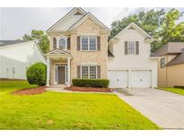 Charming two-story home featuring a well-manicured lawn and inviting entrance at 98 Coopers Glen Sw Dr, Mableton, GA 30126