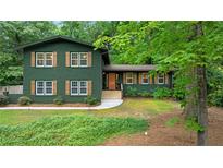 Charming two-story home featuring wood shutters, a well-maintained lawn, and mature shade trees at 3597 Embry Cir, Atlanta, GA 30341