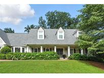 Charming home featuring a well-manicured lawn and beautiful landscaping, enhancing its curb appeal at 4824 Dunwoody Station Dr, Atlanta, GA 30338