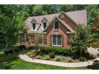 Charming brick home featuring lush landscaping, dormer windows and a well-manicured lawn at 17 Shotgun Nw Rd, Cartersville, GA 30121