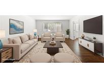 Bright living room features hardwood floors, plush seating, stylish decor, and a flat-screen TV at 115 Biscayne Nw Dr # F1, Atlanta, GA 30309