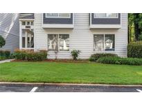 Charming exterior of a two-story condo with well-maintained lawn and landscaping at 47 Arbor End, Smyrna, GA 30080