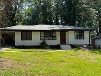Charming single-story home with a well-maintained lawn and inviting curb appeal at 1968 Rosewood Rd, Decatur, GA 30032