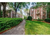 Beautiful brick condos with a well-maintained walkway and lush green landscaping for a park-like setting at 2260 Peachtree Nw Rd # B4, Atlanta, GA 30309