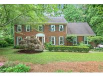 Charming two-story brick home with a manicured lawn and mature landscaping at 4810 Lismoor Trce, Mableton, GA 30126