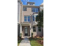 Charming multi-story home featuring a brick facade, multiple windows, and a well-maintained front yard at 547 Fundao Ln # 24, Lawrenceville, GA 30046