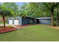 Charming single story home with attached two-car garage and lush green lawn at 30 Roseberry Dr, Stockbridge, GA 30281