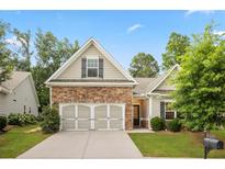 Charming home with a stone facade and well-manicured front lawn, inviting and perfect for families at 263 Jefferson Ave, Canton, GA 30114
