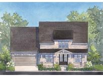 Charming home featuring stone accents, a covered entrance, and a two-car garage, surrounded by lush greenery at 5315 Keepsake Court, Cumming, GA 30040